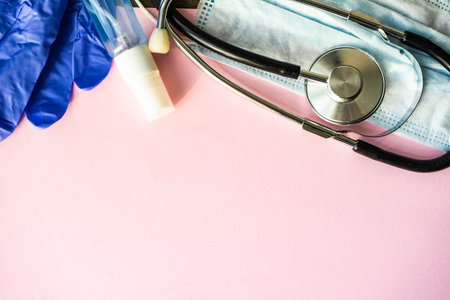 COVID-19 virus concept with face mask on pastel background with copy spaceの写真素材