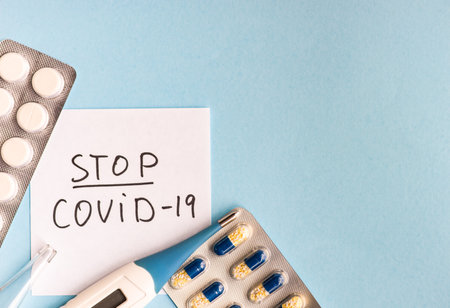 COVID-19 virus concept with pills and other safe staff  on pastel background with copy space