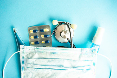 COVID-19 virus concept with pills and other safe staff  on pastel background with copy spaceの写真素材