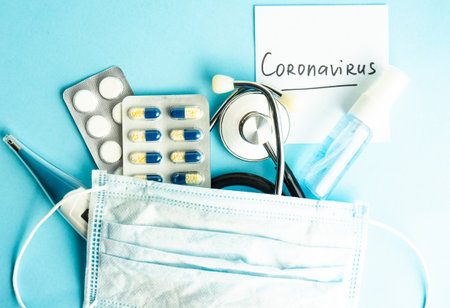 COVID-19 virus concept with pills and other safe staff  on pastel background with copy spaceの写真素材