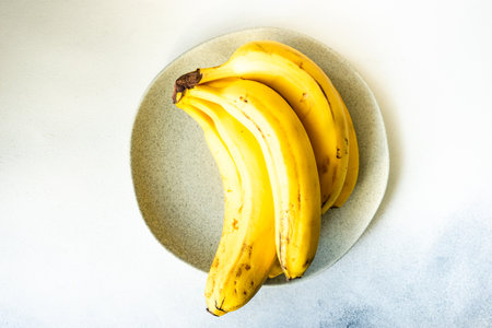 Organic food concept with fresh raw banana fruit on concrete background with copy spaceの写真素材