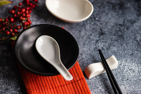 Asian table setting with wooden chopsticks and ceramic bowls on stone background with copy spaceの写真素材