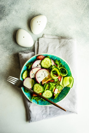 Healthy lifestyle food concept with mixed vegetable salad and seeds on rustic stone background with copy spaceの写真素材