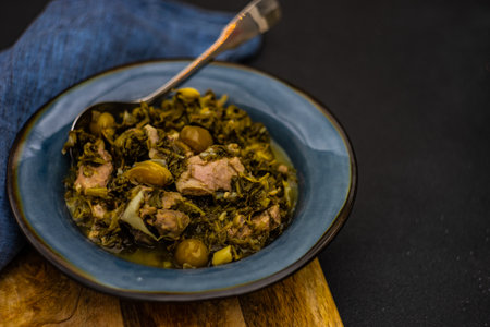 Chakapuli is a Georgian stew with tarragon and meat served in ceramic bowl on stone backgroundの写真素材