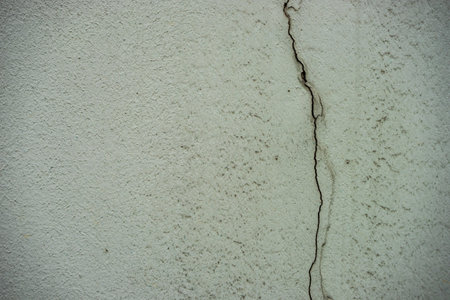 Old wall with crack as a constructing background with copy space