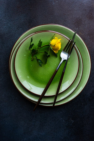 Table setting with yellow roses and cutlery on rustic table with copy spaceの写真素材