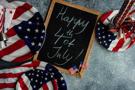 Table setting concept with 4th of July or USA Independence Day with flags on concrete background with copy spaceの写真素材
