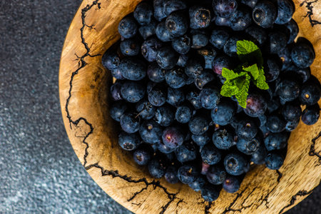 Organic blueberry fruits on concrete background with copy spaceの写真素材