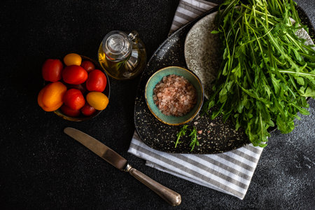 Healthy food concept with fresh organic arugula herb leaves on stone background with copy spaceの写真素材