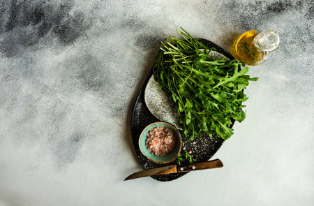 Healthy food concept with fresh organic arugula herb leaves on stone background with copy spaceの写真素材