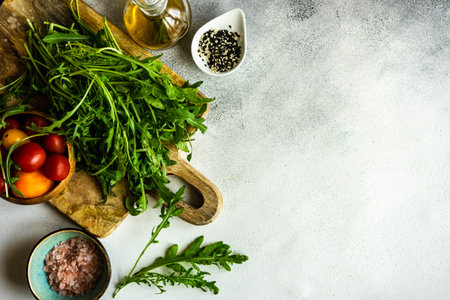 Healthy food concept with fresh organic arugula herb leaves on stone background with copy spaceの写真素材