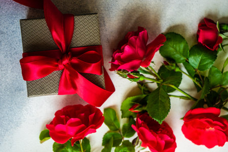 Fresh red roses on concrete background with copy space as a gift card conceptの写真素材