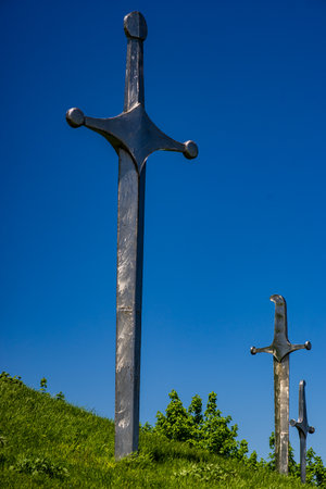 Famous Didgori battle monument with giant swards and sculptures of soldiers close to Tbilisi in Caucasus mountain range in summer time as a travel cardのeditorial素材