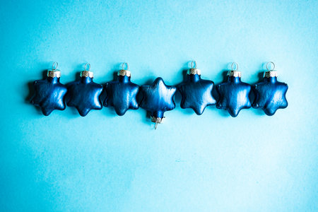 Christmas season frame made with wooden blocks on blue background with copy spaceの写真素材