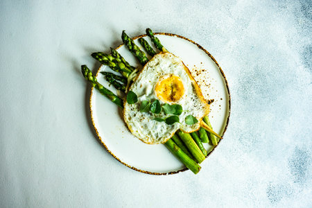 Organic grilled asparagus served for healthy keto lunch on stone background with copy spaceの写真素材