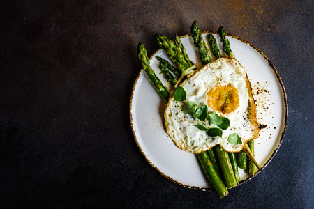 Organic grilled asparagus served for healthy keto lunch on stone background with copy spaceの写真素材
