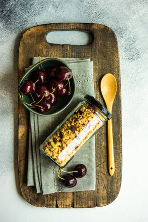 Healthy breakfast concept with glass jar full of oatmeal on concrete background with copy spaceの写真素材