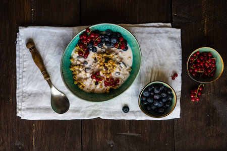 Breakfast food concept with cereals, yogurt and berries on concrete background with copy space