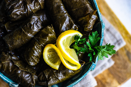 Traditional georgian tolma in vine leaves on rustic background with copyspaceの写真素材