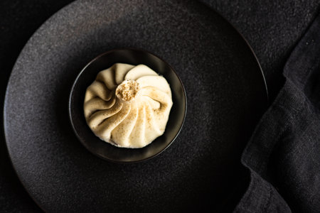 Traditional georgian dampling known as khinkali in georgian on black plate, served with black napkin...