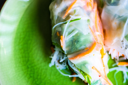 Spring roll served on bright green plateの写真素材