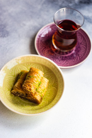 Famous turkish or oriental delight Baklava served with black teaの写真素材