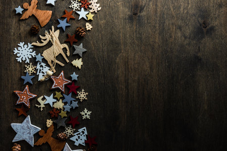Christmas cad concept with holiday wooden decoration on dark moody background with copy spaceの写真素材