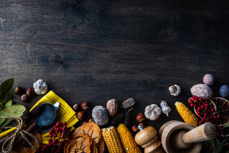 Thanksgiving day or autumnal harvest concept with frame with nuts, berries, vegetable and fruits on dark wooden background with copy spaceの写真素材