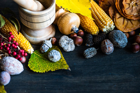 Thanksgiving day or autumnal harvest concept with frame with nuts, berries, vegetable and fruits on dark wooden background with copy spaceの写真素材