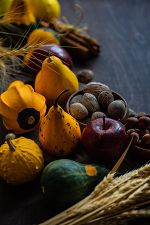 Thanksgiving card concept with autumnal hatvest vegetable, fruits and nuts on rustic wooden background with copy spaceの写真素材