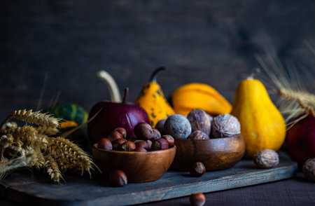 Thanksgiving card concept with autumnal hatvest vegetable, fruits and nuts on rustic wooden background with copy spaceの写真素材