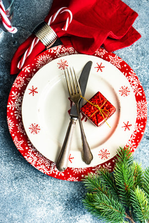 Plate and cutlery served for Christmas festive dinner on concrete background with copy spaceの写真素材