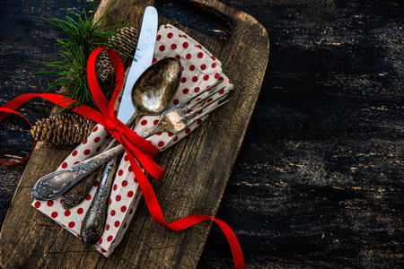 Table setting on vintage and rustic wooden background with cutkery decorated with ribbonの写真素材