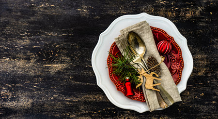 Table setting on vintage and rustic wooden background with cutkery decorated with ribbonの写真素材