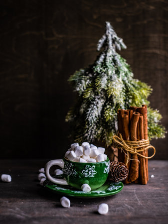 Christmas holiday flatlay with evergreen xmas tree and marshmallow on wooden background with copy spaceの写真素材