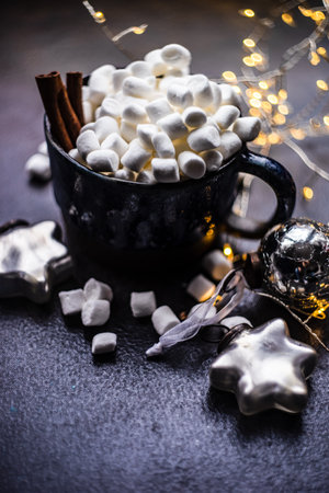 Christmas holiday flatlay with evergreen xmas tree and marshmallow on wooden background with copy spaceの写真素材