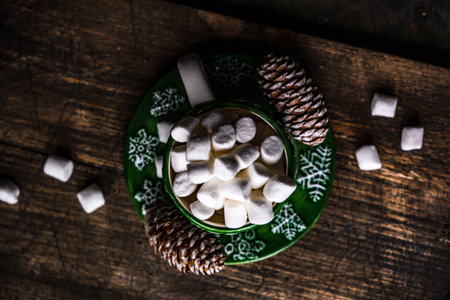 Christmas holiday flatlay with evergreen xmas tree and marshmallow on wooden background with copy spaceの写真素材