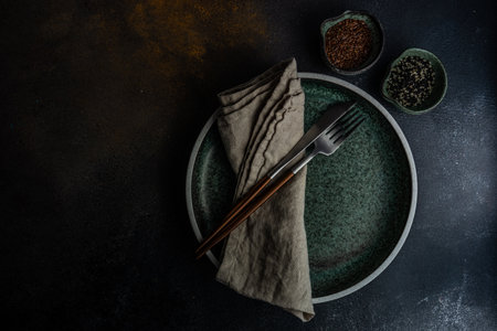 Rustic table setting with empty plate and cutlery set on concrete background with copy spaceの写真素材