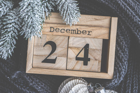 Christmas card concept with wooden calendar, knitted scarf and decoration