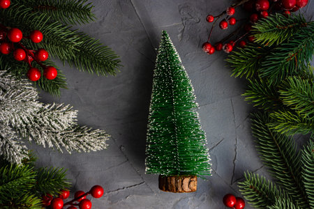 Christmas frame with xmas tree branches and festive ornament on concrete background