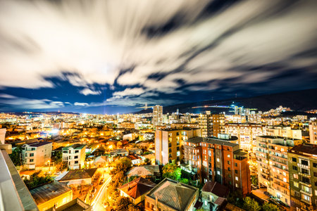 Running clouds in night sky over Tbilisi city centre, Georgiaの写真素材