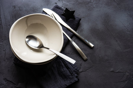 Modern simply place setting on black concrete background with copy spaceの写真素材