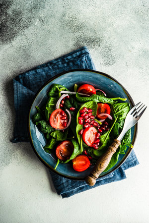 Healthy food concept with fresh organic spinach leaves salad on rustic background with copy spaceの写真素材