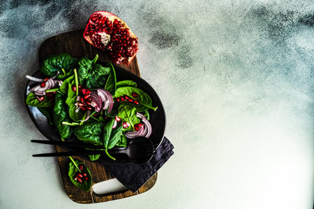 Healthy food concept with fresh organic spinach leaves salad on rustic background with copy spaceの写真素材