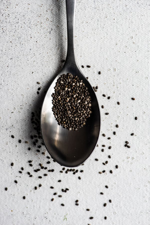Organic food concept with healthy chia seeds in spoon on concrete backgroundの写真素材