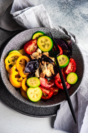 Healthy gourmet salad with vegetables and feijoa served in a bowl on tableの写真素材