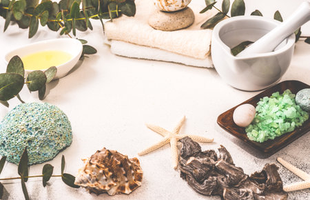 Healthcare concept with fresh eucalyptus leaves, salt and oil on stone backgroundの写真素材