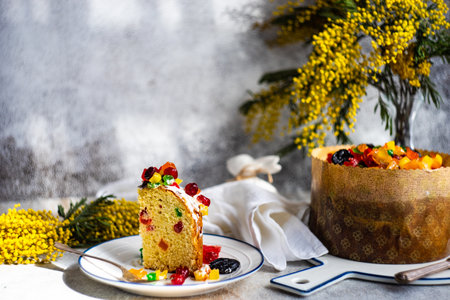 Easter food concept with traditional cake and colored eggs decorated with spring flowersの写真素材