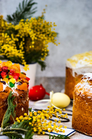 Easter food concept with traditional cake and colored eggs decorated with spring flowers