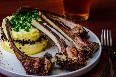 Baked smoked pork ribs with sauces served on wooden tableの写真素材